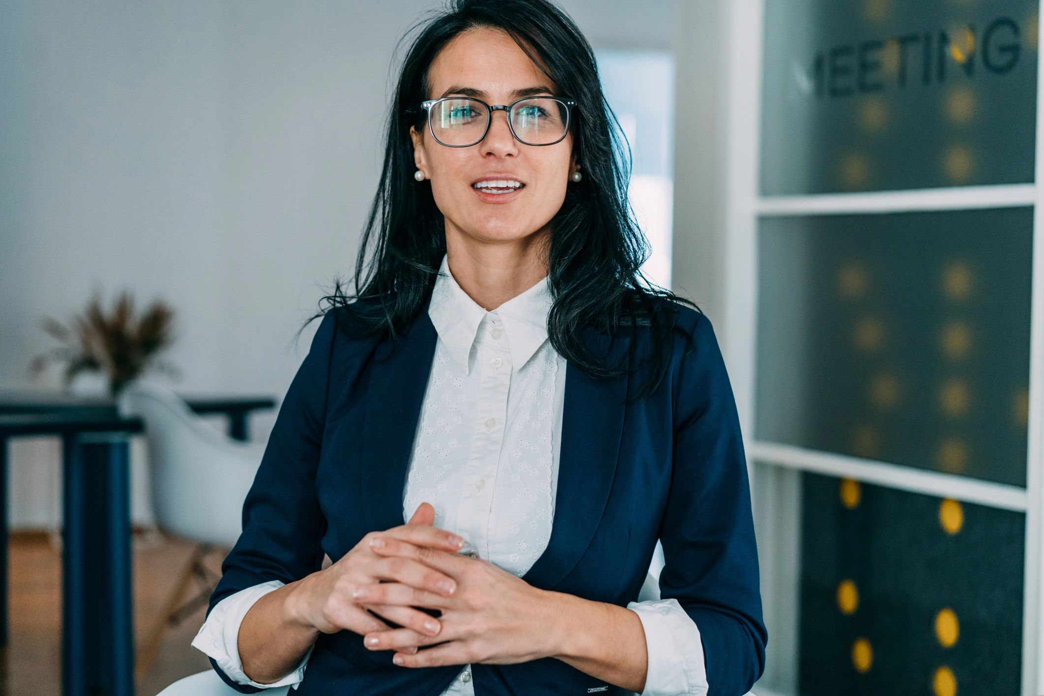 Professional headshot-style photo of a woman speaking on a video call