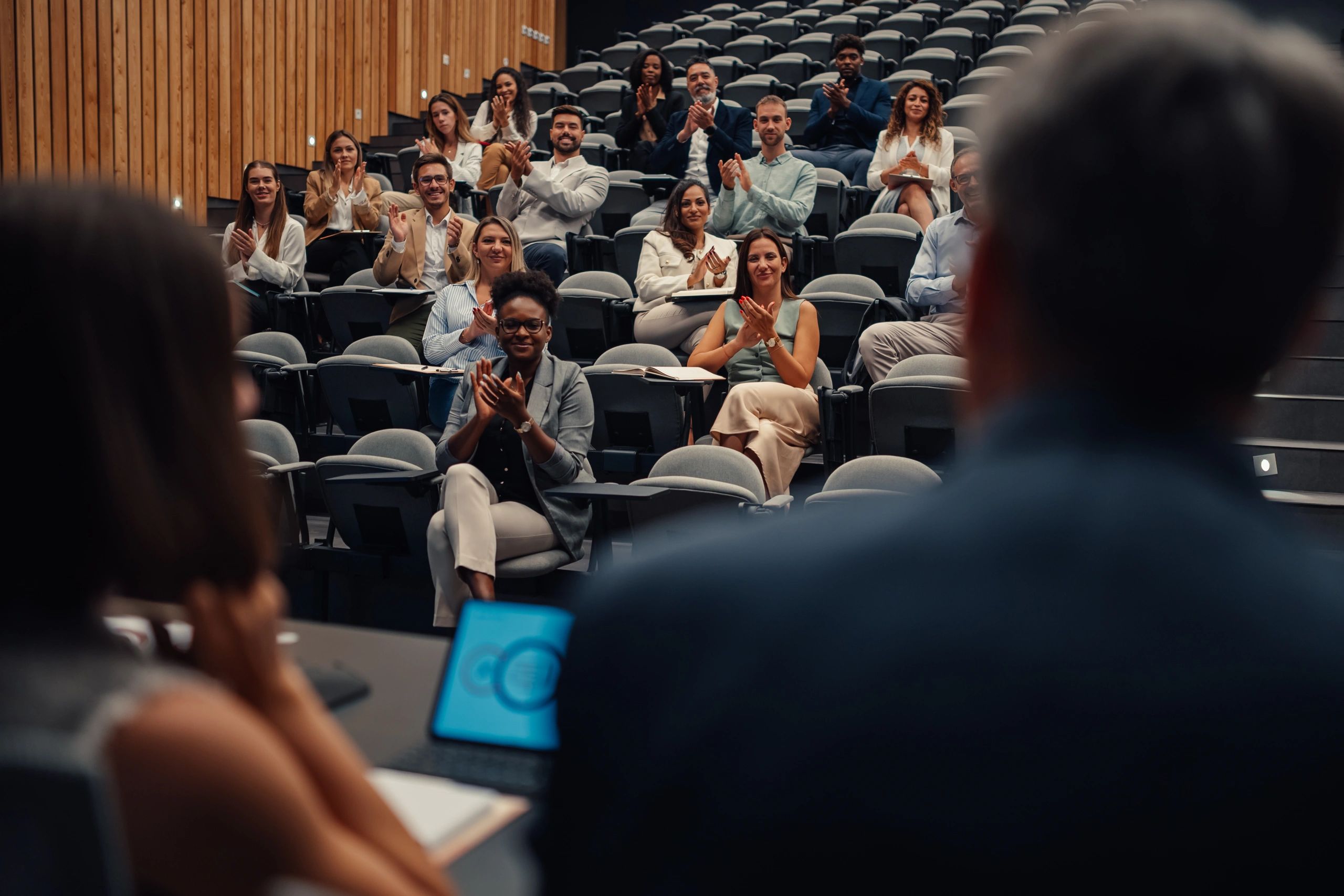 Audience applauding at a seminar